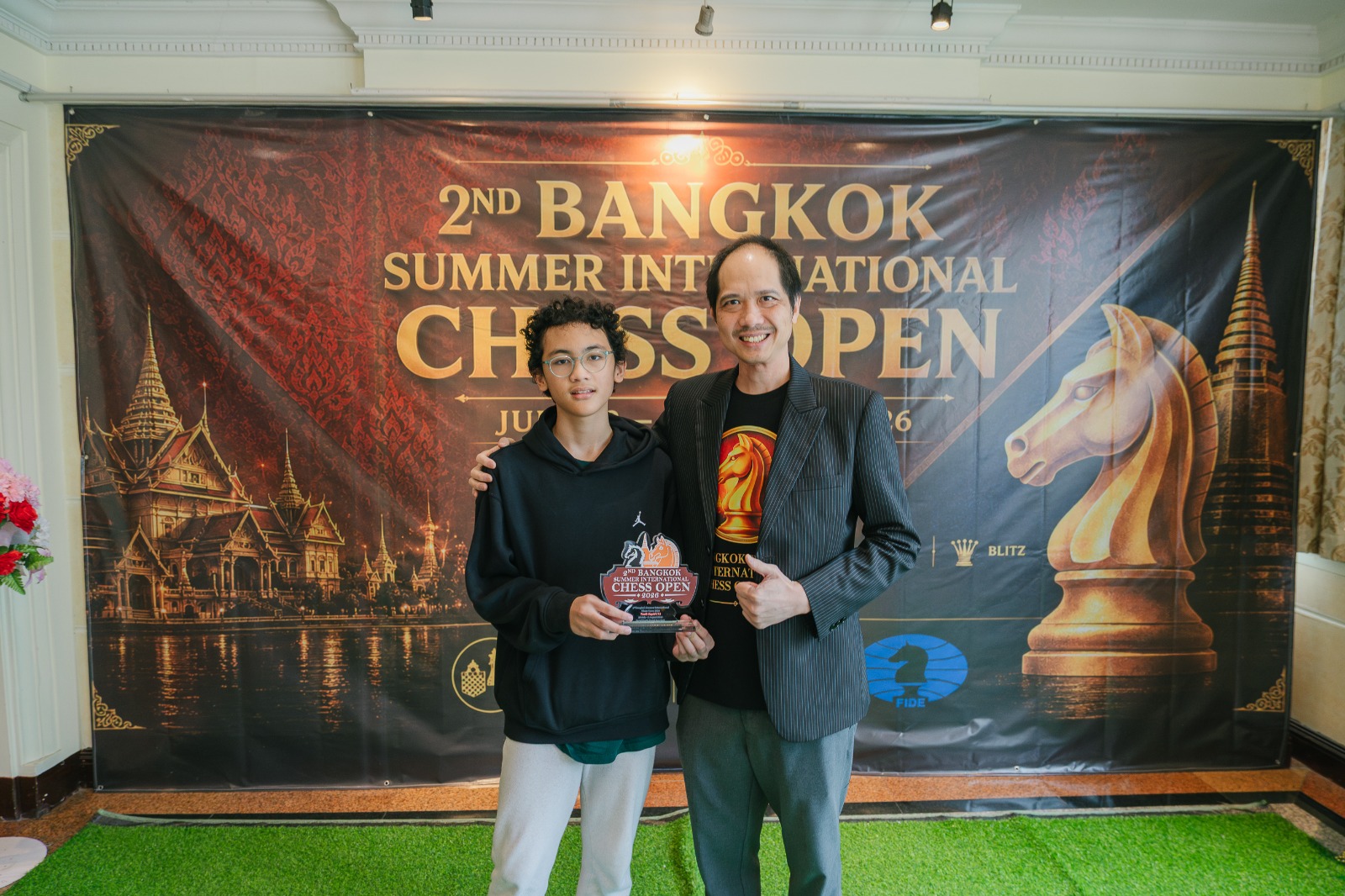 Naro holding his trophy after winning a youth rapid chess tournament in Bangkok